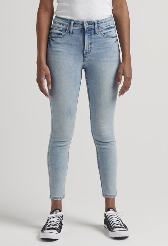 Women’s girlfriend fit slim leg jeans featuring a mid rise and destroyed dark indigo wash