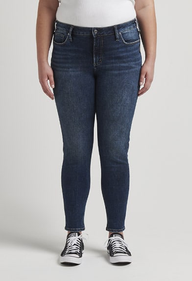 Plus size curvy fit straight leg jeans featuring a mid rise and dark indigo wash