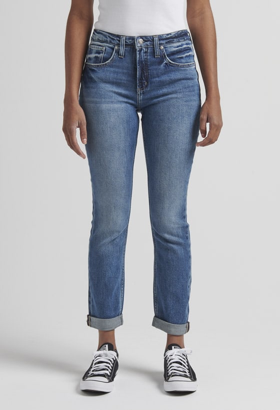 Women’s girlfriend fit slim leg jeans featuring a mid rise and destroyed dark indigo wash