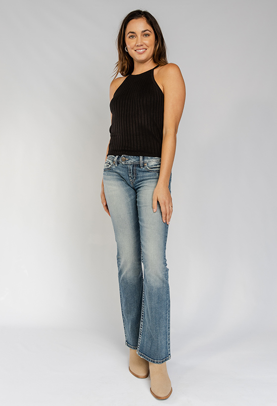 Women’s universally flattering slim bootcut jeans featuring a low rise and medium indigo wash