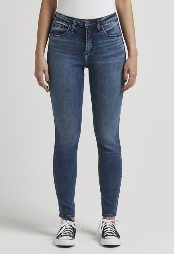 Women’s universally flattering skinny bootcut jeans featuring a mid rise and dark indigo wash