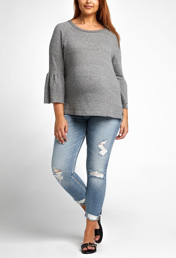 Women’s girlfriend fit slim leg jeans featuring a mid rise and destroyed dark indigo wash